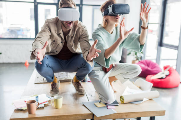 istock selective focus of excited female and male architects gesturing with hands while having virtual reality experience in loft office 1152651554