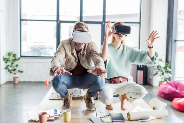 istock excited female and male architects gesturing with hands while having virtual reality experience in loft office 1152651566
