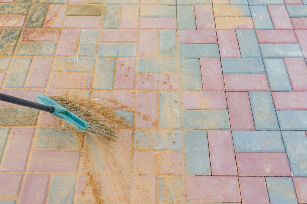 istock Broom swipes paved walkway grouted with sand 1152653117