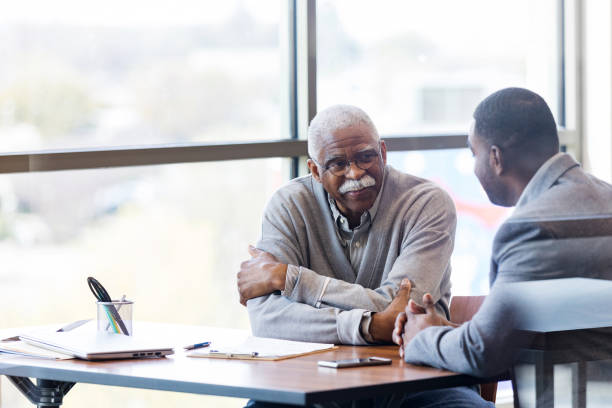 istock Unrecognizable banker takes time to visit with senior customer 1152654557