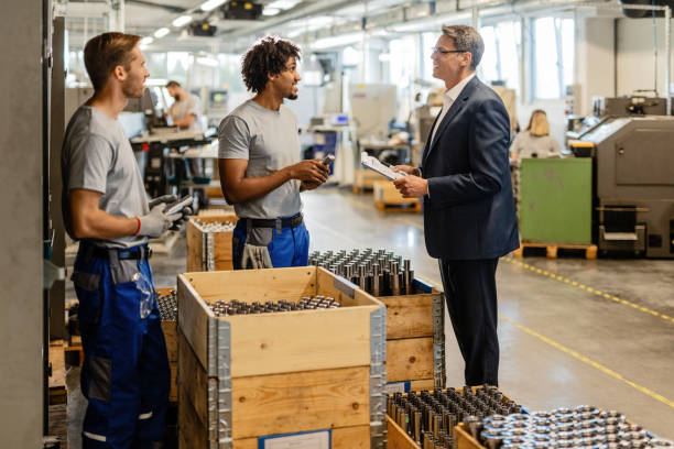 istock Happy businessman talking with metal workers while visiting the production facility. 1152654593