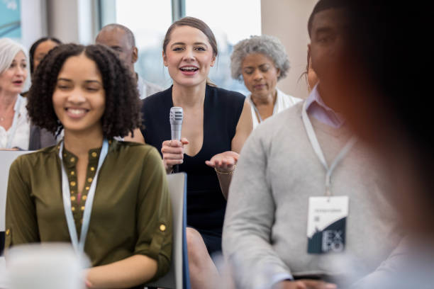istock Caucasian member of audience asks the presenter a question 1152654643
