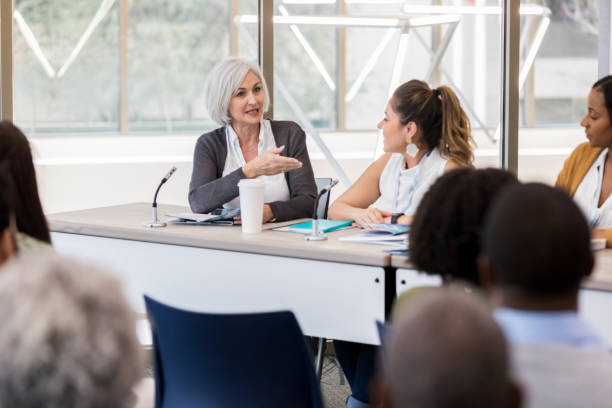 istock Moderator gestures toward fellow expo panelists 1152654658
