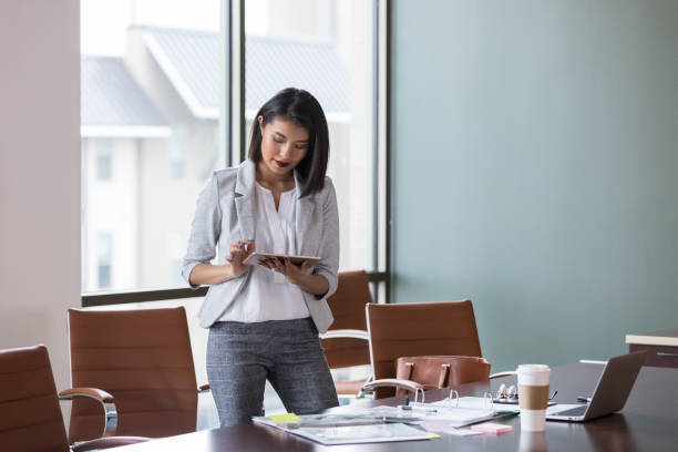 istock Attractive young businesswoman using digital tablet 1152654707