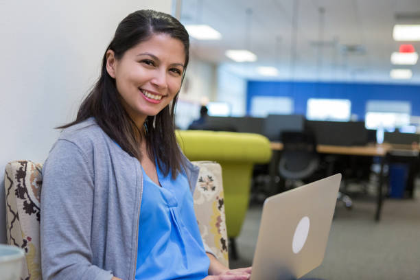 istock Confident adult student uses laptop in library 1152654857