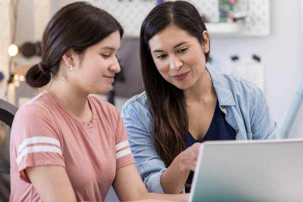 istock Hispanic mother and daughter work on school project together 1152654974