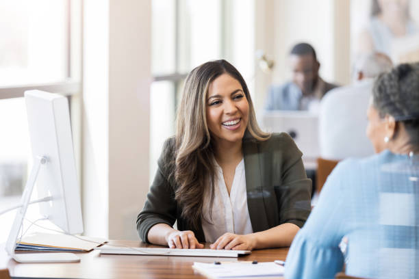 istock Cheerful bank employee opens account for customer 1152654976