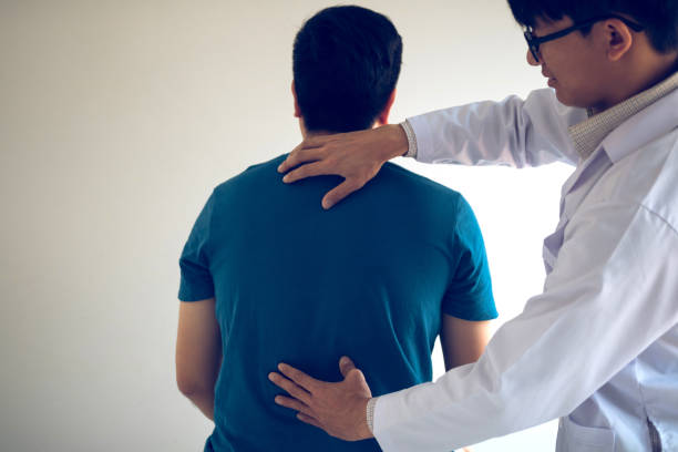 istock Physical therapists are using hands to check the back of the patient. 1152654977