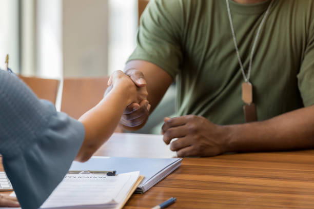 istock Unrecognizable soldier shakes hands with loan officer 1152655003