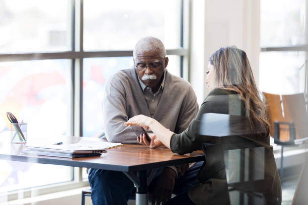 istock Senior man learns to use mobile banking app 1152655004