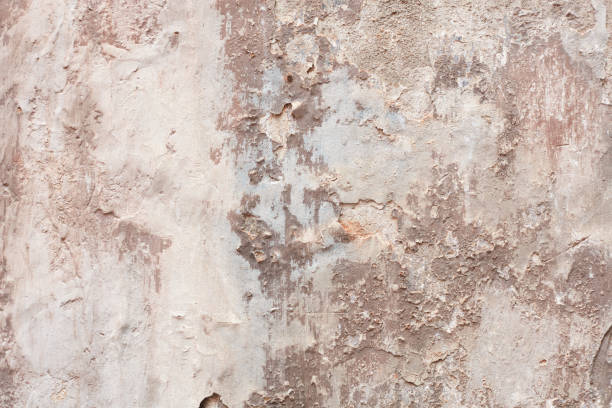 istock Old beige chipped wall with humidity stains texture background 1152655019