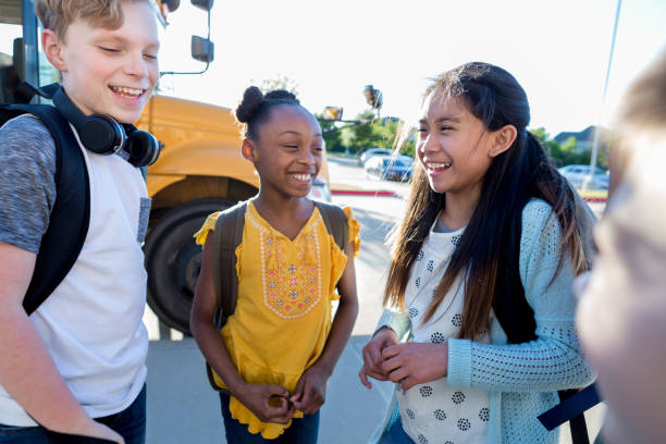 istock Friends laugh and joke at bus stop 1152655182