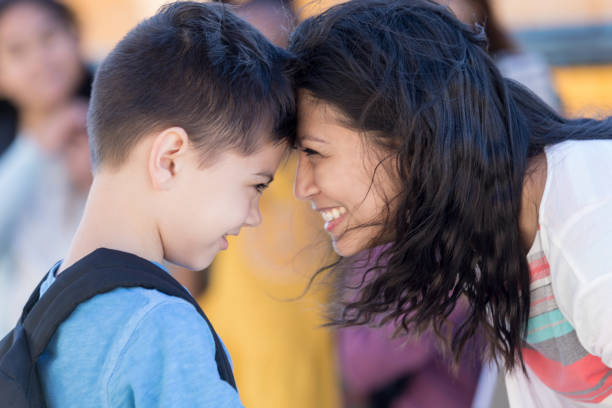 istock Mom tenderly encourages son at bus stop 1152655193