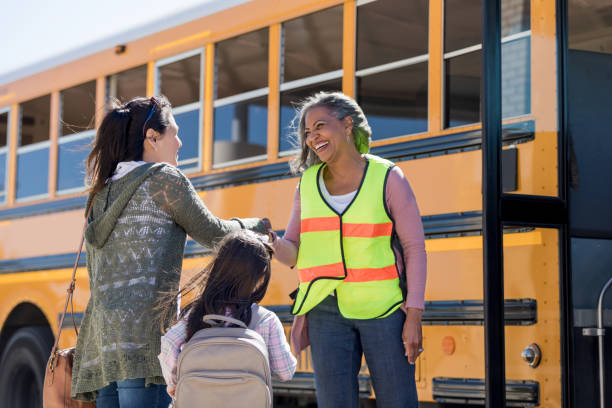 istock Mid adult mom greets school bus driver 1152655352