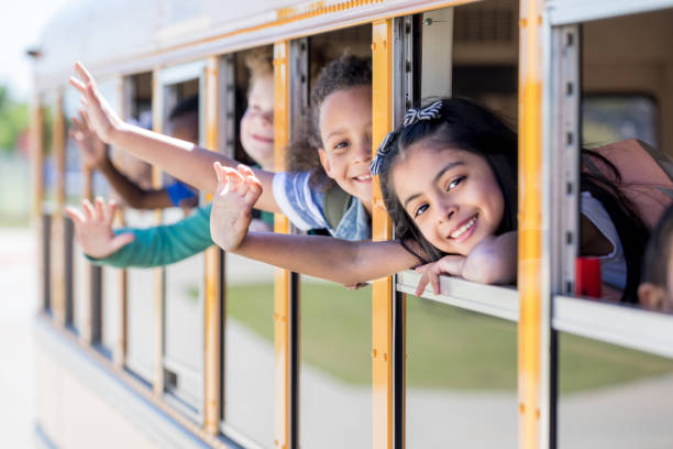 istock Cute school children in school bus 1152655403