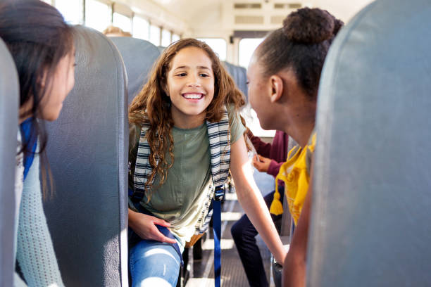 istock Three friends gossip about schoolmates on bus 1152655498