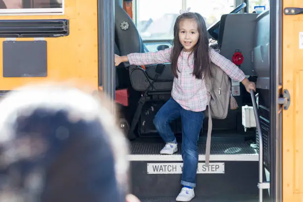 Photo of Elementary schoolgirl sees her mother waiting for her