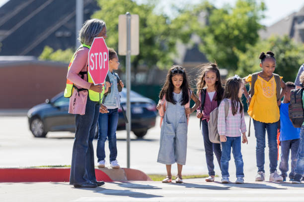 istock Children wait for crossing guard's signal 1152655609