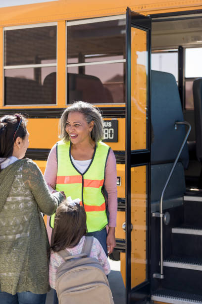 istock Two women shake hands at the bus stop 1152655628