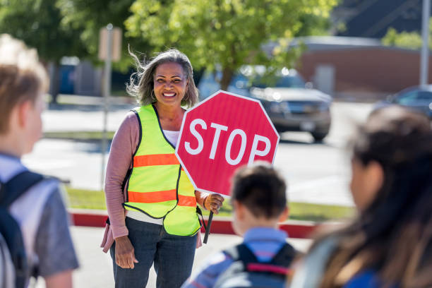 istock Crossing guard tells children to stop 1152655678