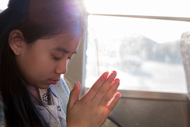 istock Junior high student prays on school bus 1152656353