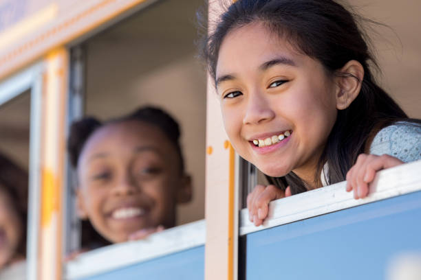 istock Junior high schoolgirl smiles at camera from bus 1152656365