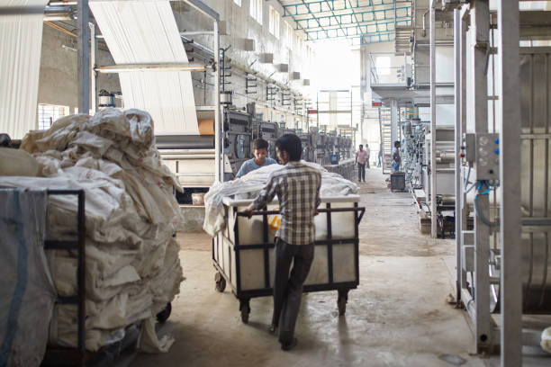 istock Indian Manufacturing Workers Pushing Carts in a Factory 1152656386
