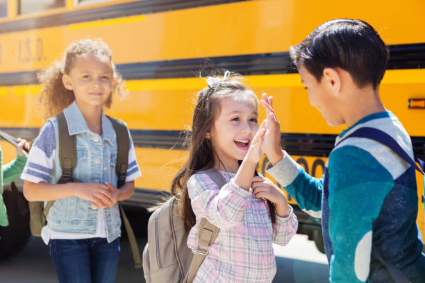 istock Friends high-five while waiting at the bus stop 1152656415