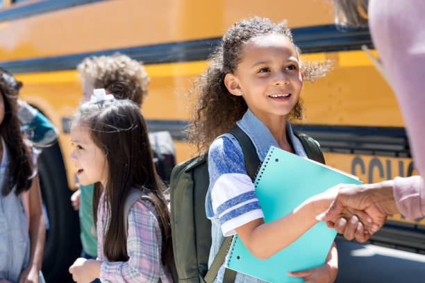 istock Young female student shakes teacher's hand 1152656439