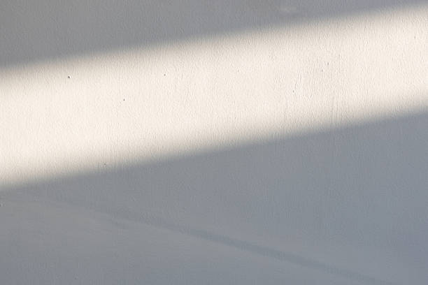 istock simplicity empty white cement wall with line of sun light and shadow at afternoon. used for template, background or texture. 1152656520