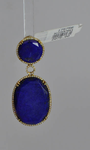 istock Elegant loop earrings with blue marble and golden stone at bottom with white background 1152656814