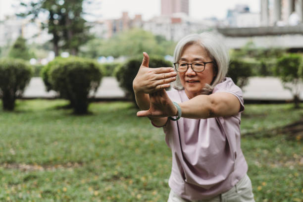 istock Senior lady practicing yoga at the public park 1152656889