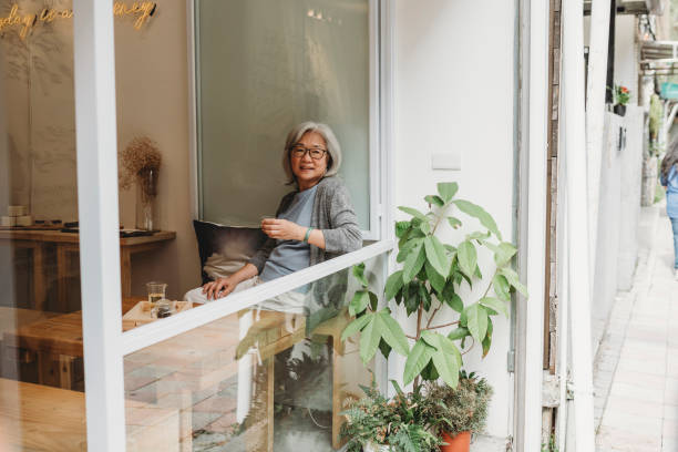 istock Mature lady drinking tea at the cafe 1152656993
