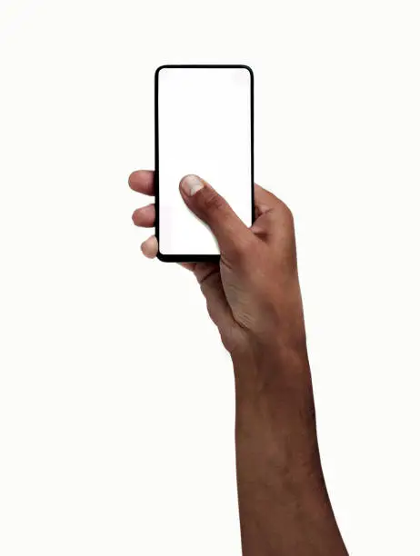 Man hand holding and touching a mobile phone screen with his thumb on a white isolated background