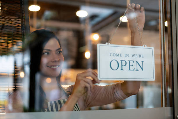 istock Manager putting an open sign on the door at a restaurant 1152658692