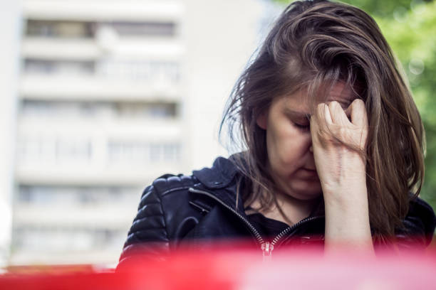istock Woman holding her forehead with one hand 1152660355