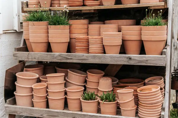 Terracotta clay pots for garden plants and flowers. Decorative flower pots and vases outside. Flower business