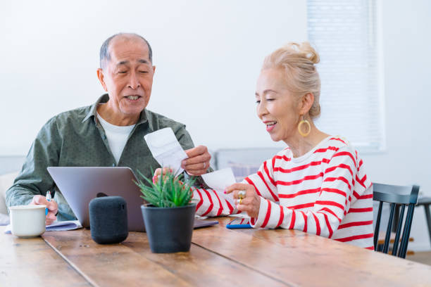 istock Happy senior couple using laptop at home 1152661747