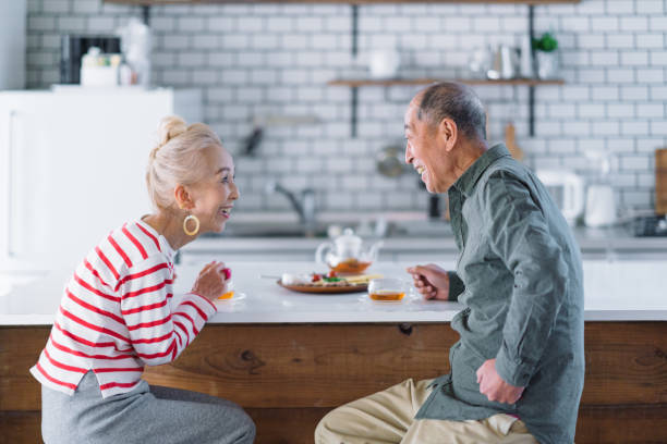 senior couple having tea in kitchen - salad japanese culture japan asian culture imagens e fotografias de stock