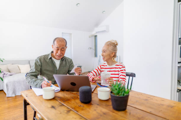 istock Happy senior couple using laptop at home 1152661850
