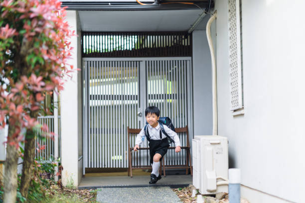 Excited boy leaving home for school An excited boy is leaving home for school.hurry, rushing schools  stock pictures, royalty-free photos & images
