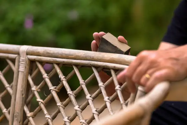 Man Hand Making Sander on Wooden Chair