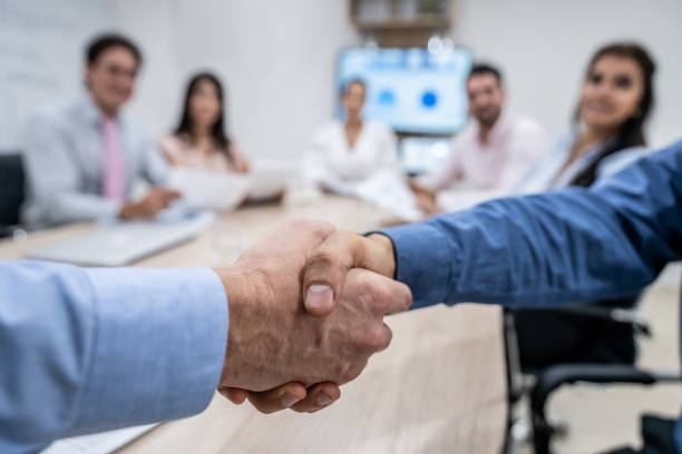 istock Unrecognizable people in a business meeting handshaking 1152666310