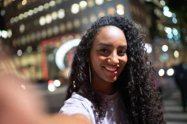 istock Latin woman taking a selfie at night 1152667752