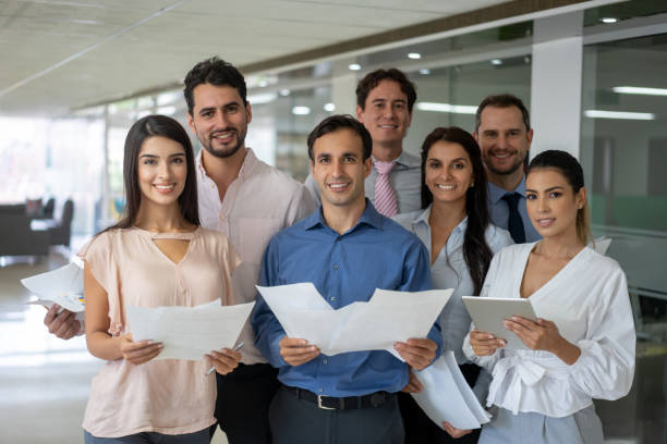 istock Successful business team at the office holding tablet and documents all facing camera very confident 1152667927