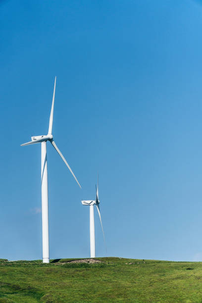 istock Renewable Energy Systems. Wind Turbine Power station with a Clear Blue Sky Behind. 1152668917