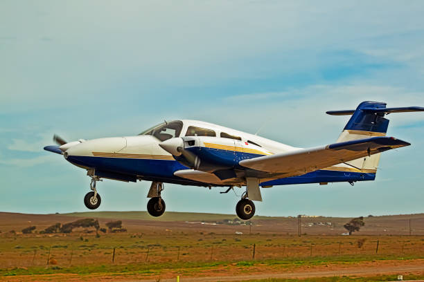 istock Low flying blue and white twin engine aircraft 1152669092