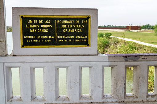 USA Mexican Border demarcation sign on international bridge crossing between McAllen Texas and Progreso in Mexico
