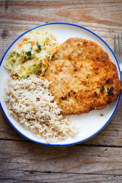 istock Polish breaded pork cutlet with rice and vegetable salad 1152674301
