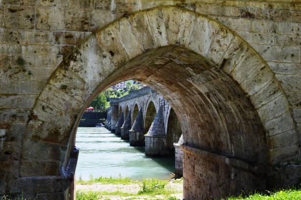 istock the arch of the old stone bridge 1152674404